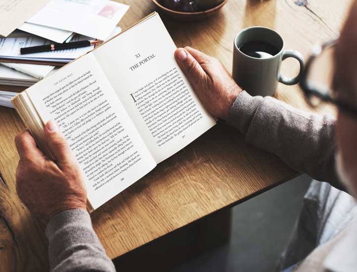 Fiction book design being read casually in a coffee shop.